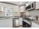 Modern kitchen with stainless steel appliances, granite countertops, and white cabinets at 1591 Athens Sw Ave, Atlanta, GA 30310