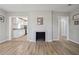Open living room with hardwood floors, fireplace, and passage to other rooms at 1591 Athens Sw Ave, Atlanta, GA 30310