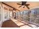 Enclosed porch featuring ceiling fans and views of the surrounding forest at 2405 Millwater Xing, Dacula, GA 30019