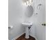 Charming half bathroom featuring a pedestal sink, decorative lighting, and stylish fixtures at 2405 Millwater Xing, Dacula, GA 30019