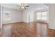 Spacious bedroom with wood floors, large windows with natural light, and a ceiling fan at 2405 Millwater Xing, Dacula, GA 30019