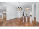 Open dining area features dark wood floors, white columns, trim and a view of the kitchen at 2405 Millwater Xing, Dacula, GA 30019