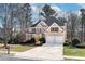 Beautiful two-story home with a manicured lawn and a two-car garage in a wooded neighborhood at 2405 Millwater Xing, Dacula, GA 30019