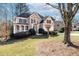Inviting two-story home with a charming front porch, lush lawn, and attached two-car garage at 2405 Millwater Xing, Dacula, GA 30019