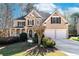 Charming two-story home with a well-manicured lawn, two-car garage, and inviting front porch at 2405 Millwater Xing, Dacula, GA 30019