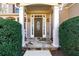 Inviting front entrance with stone walkway, a decorative oval window door, and green bushes at 2405 Millwater Xing, Dacula, GA 30019