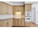 Close up of the kitchen featuring light wood cabinets and built in double oven at 2405 Millwater Xing, Dacula, GA 30019