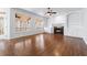 Bright living room features wood floors, fireplace, and access to the back porch at 2405 Millwater Xing, Dacula, GA 30019