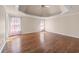 Spacious main bedroom featuring tray ceiling, hardwood floors, and bright windows at 2405 Millwater Xing, Dacula, GA 30019