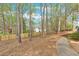 Spacious backyard featuring a new wooden fence, mature trees and walkway at 4162 Crowder Nw Dr, Kennesaw, GA 30152