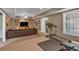 Finished basement offering a comfortable entertainment area with a sofa, TV, and workout equipment at 4162 Crowder Nw Dr, Kennesaw, GA 30152
