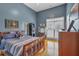 Cozy bedroom with blue walls, wood floors, a large window, and comfortable furnishings at 4162 Crowder Nw Dr, Kennesaw, GA 30152
