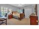 Bedroom with natural light, a wooden sleigh bed, carpeted floors, and a closet for storage, creating a restful retreat at 4162 Crowder Nw Dr, Kennesaw, GA 30152