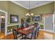 Elegant dining room with hardwood floors, wainscoting, and a stylish chandelier above the table at 4162 Crowder Nw Dr, Kennesaw, GA 30152