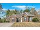 Charming single-story brick home featuring manicured landscaping and a well-maintained front yard with mature trees at 4162 Crowder Nw Dr, Kennesaw, GA 30152