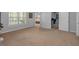 Bright, carpeted living room features an open layout with views into an adjacent bedroom and home office at 4162 Crowder Nw Dr, Kennesaw, GA 30152