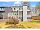 Landscaped backyard features a deck with screened porch underneath, lush lawn, and privacy fence at 1299 Sunland Ne Dr, Brookhaven, GA 30319
