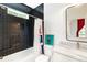 Modern bathroom boasts dark tiled walls, shower, and marble countertop sink at 1299 Sunland Ne Dr, Brookhaven, GA 30319