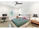 Modern bedroom features polished concrete floors, neutral decor, ceiling fan, and natural light at 1299 Sunland Ne Dr, Brookhaven, GA 30319