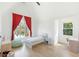 Bright bedroom features red curtains, hardwood floors, and large window at 1299 Sunland Ne Dr, Brookhaven, GA 30319