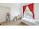Bright bedroom features red curtains, hardwood floors, and large window at 1299 Sunland Ne Dr, Brookhaven, GA 30319