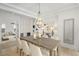 Formal dining room with a wooden table, seating for eight, contemporary chandelier, and hardwood floors at 1299 Sunland Ne Dr, Brookhaven, GA 30319