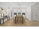 Formal dining room with a wooden table, seating for eight, contemporary chandelier, and hardwood floors at 1299 Sunland Ne Dr, Brookhaven, GA 30319