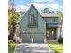 Charming two-story green home featuring a paved driveway, two-car garage, and a well-manicured lawn at 1299 Sunland Ne Dr, Brookhaven, GA 30319