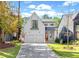 Charming two-story white home featuring a paved driveway, two-car garage, and a well-manicured lawn at 1299 Sunland Ne Dr, Brookhaven, GA 30319
