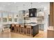 Spacious kitchen featuring a large island with seating, modern appliances, and stylish pendant lighting at 1299 Sunland Ne Dr, Brookhaven, GA 30319