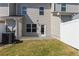 Backyard with grass and a white fence with a patio and exterior door at 310 Ashigan St, Union City, GA 30291