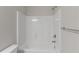 Clean bathroom featuring a shower-tub combo with white tiled walls at 310 Ashigan St, Union City, GA 30291