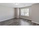 Bright and airy bedroom with hardwood floors and a large window offering ample natural light at 310 Ashigan St, Union City, GA 30291