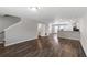 Open-concept living room with hardwood floors seamlessly connects to the kitchen and dining area at 310 Ashigan St, Union City, GA 30291