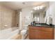 Modern bathroom with a tub-shower combo, granite countertop vanity, and decorative lighting at 3300 Windy Ridge Se Pkwy # 1309, Atlanta, GA 30339