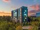 Modern high-rise condominium with reflective glass facade and verdant tree canopy at 3300 Windy Ridge Se Pkwy # 1309, Atlanta, GA 30339