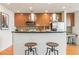 Well-lit kitchen with stainless steel appliances, wood cabinets, and a center island with stools at 3300 Windy Ridge Se Pkwy # 1309, Atlanta, GA 30339