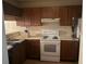 Standard kitchen featuring wooden cabinets and a white electric range at 470 Teal Ct, Roswell, GA 30076