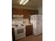 Standard kitchen featuring wooden cabinets, electric range, and refrigerator at 470 Teal Ct, Roswell, GA 30076