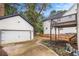Backyard featuring a two-story deck, an attached garage, and manicured landscaping at 1972 Cambridge Ave, Atlanta, GA 30337