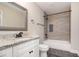 This bathroom features a single sink vanity with granite counters and a tiled shower and tub at 1972 Cambridge Ave, Atlanta, GA 30337