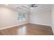 This primary bedroom has hardwood floors and a decorative trey ceiling with a ceiling fan at 1972 Cambridge Ave, Atlanta, GA 30337