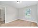 This carpeted bedroom includes views of the yard and a doorway to another room at 1972 Cambridge Ave, Atlanta, GA 30337