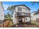 Exterior view of a home with a charming two-story deck, landscaped yard, and exposed basement at 1972 Cambridge Ave, Atlanta, GA 30337