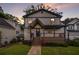 Charming home with covered front porch, complemented by lush landscaping and a well-manicured lawn at 1972 Cambridge Ave, Atlanta, GA 30337