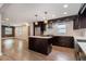Modern kitchen with stainless steel appliances, island, dark cabinets, and open floor plan at 1972 Cambridge Ave, Atlanta, GA 30337