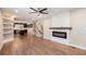 Open floor plan with living room, modern fireplace, and kitchen with island at 1972 Cambridge Ave, Atlanta, GA 30337