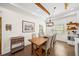 Cozy dining area with a wooden table, comfortable chairs, and a chandelier for warm lighting at 308 Reed St, Scottdale, GA 30079