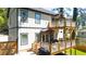 Back of home with decks on both levels, a small backyard, and a grill at 308 Reed St, Scottdale, GA 30079