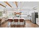 Spacious kitchen with an island, pendant lights, open shelving, stainless steel appliances, and hardwood floors at 308 Reed St, Scottdale, GA 30079